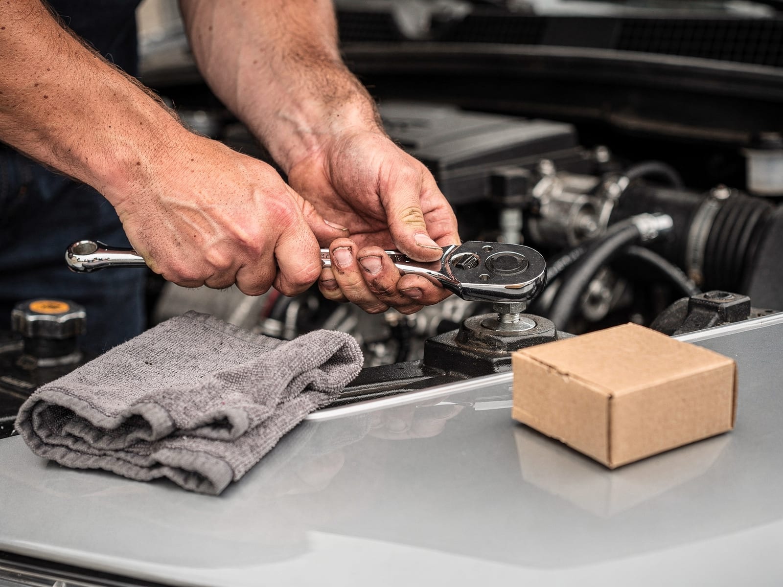 An All Pro technician torquing a bolt in a clean engine bay